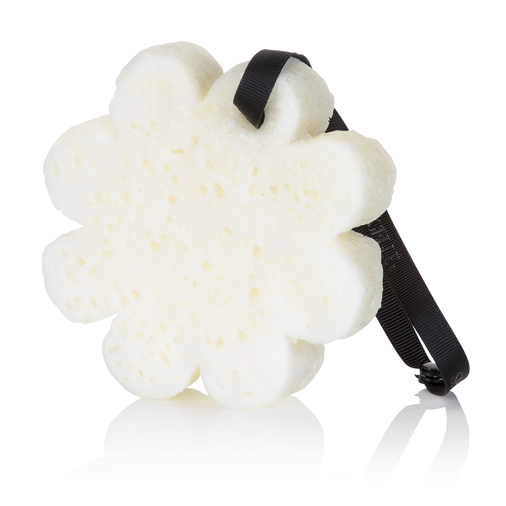 White flower-shaped body wash buffer with black hanging ribbon