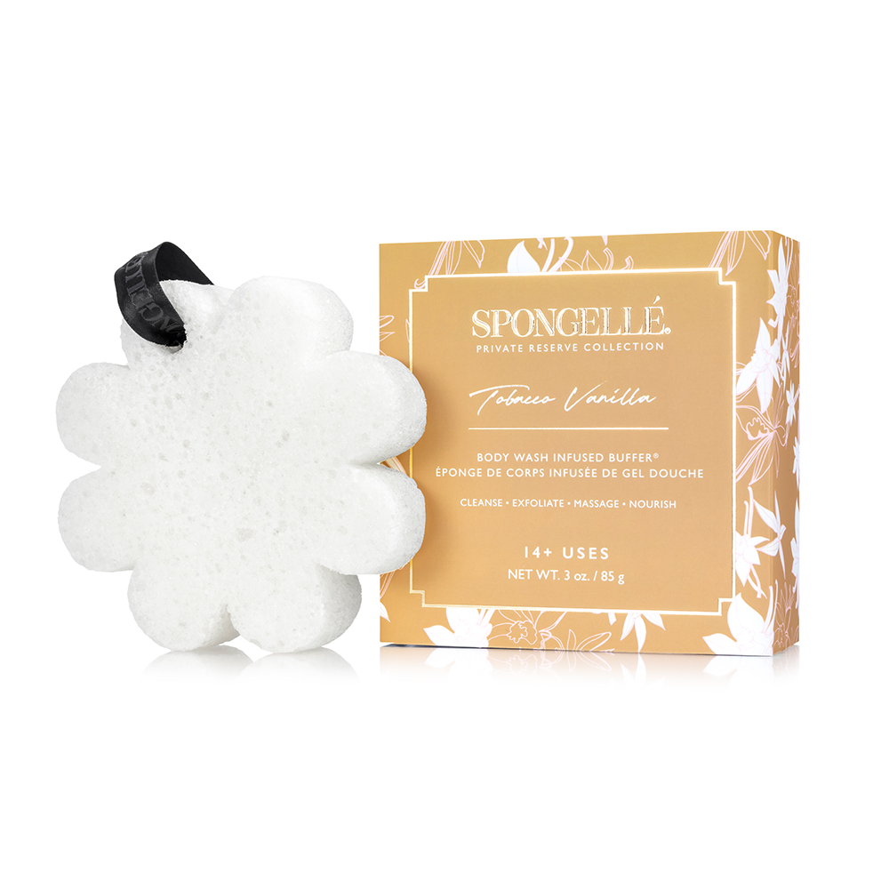 Tobacco Vanilla white flower-shaped buffer with black ribbon beside its gold-colored box